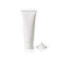 White sunscreen tube with a dab of cream on a white background